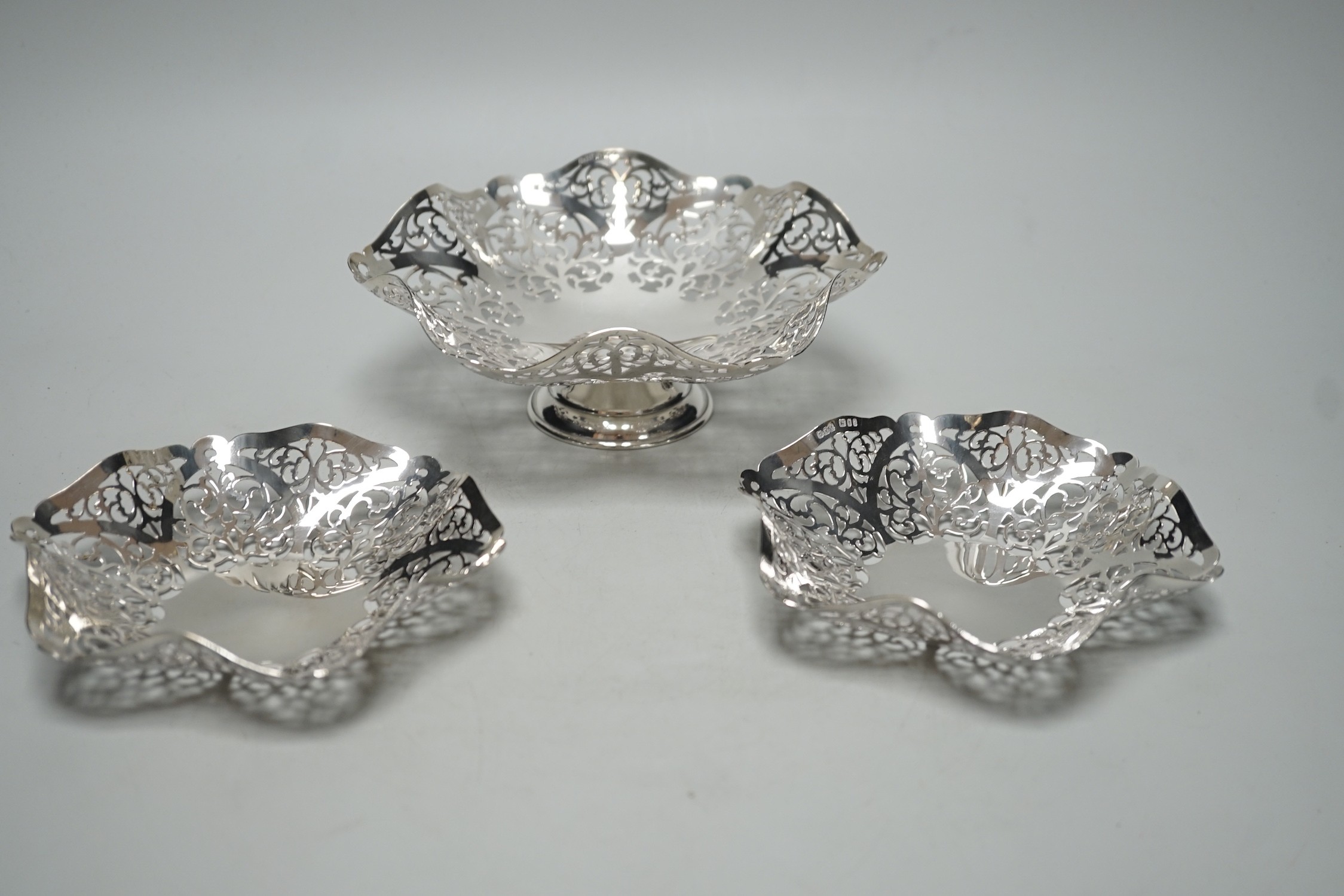 A modern suite of three Elizabeth II graduated pierced silver bonbon dishes, A. Taite & Sons Ltd, London, 1961, largest diameter 16.5cm, 11.9oz.